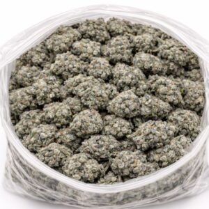 Master Kush Ultra cannabis flower buds in an open bag, showing small dense nugs with light green tones and frosty trichome coverage