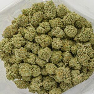 cannabis flower buds in an open bag, showing small dense nugs with light green tones and frosty trichome coverage